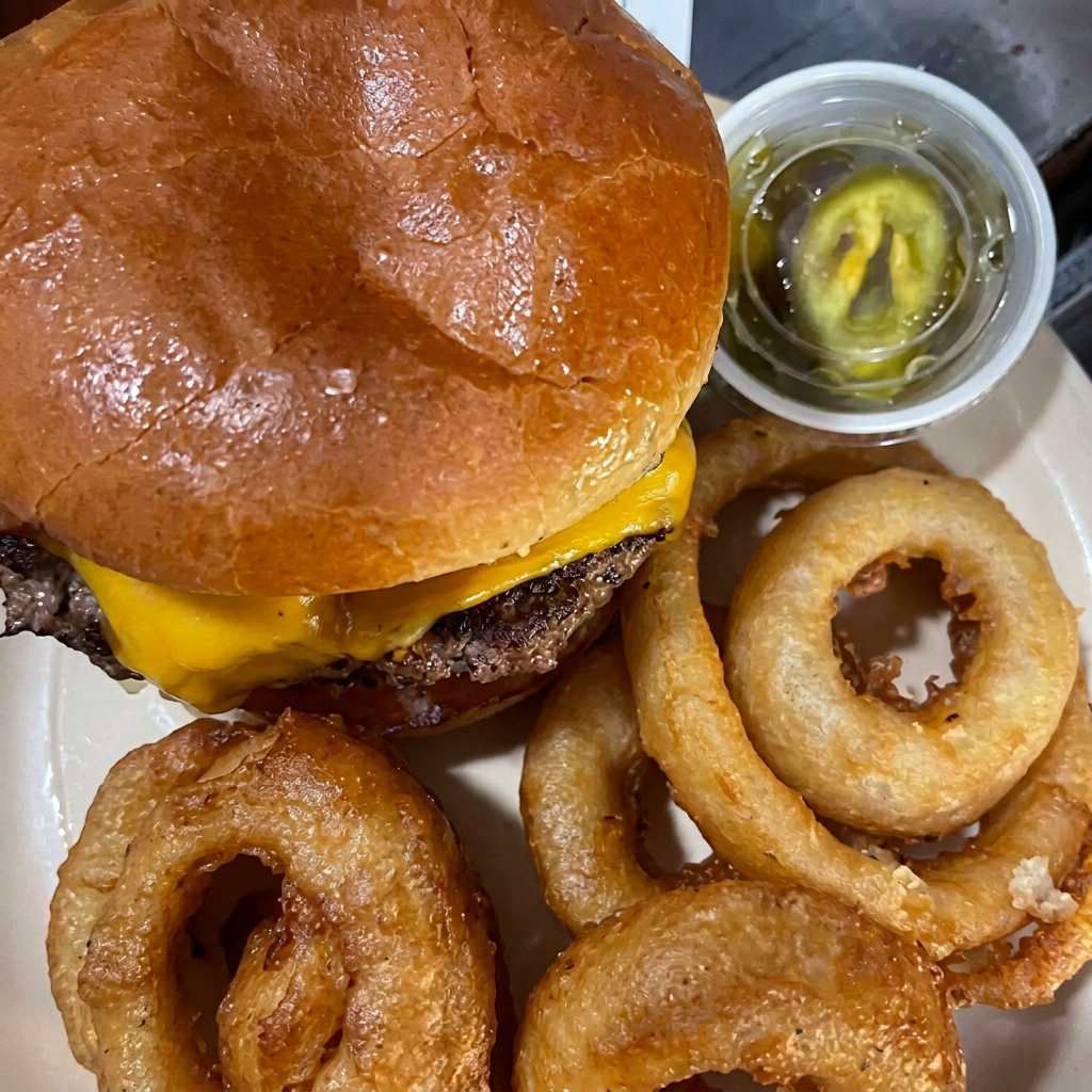 Cheeseburger served with a side of onion rings